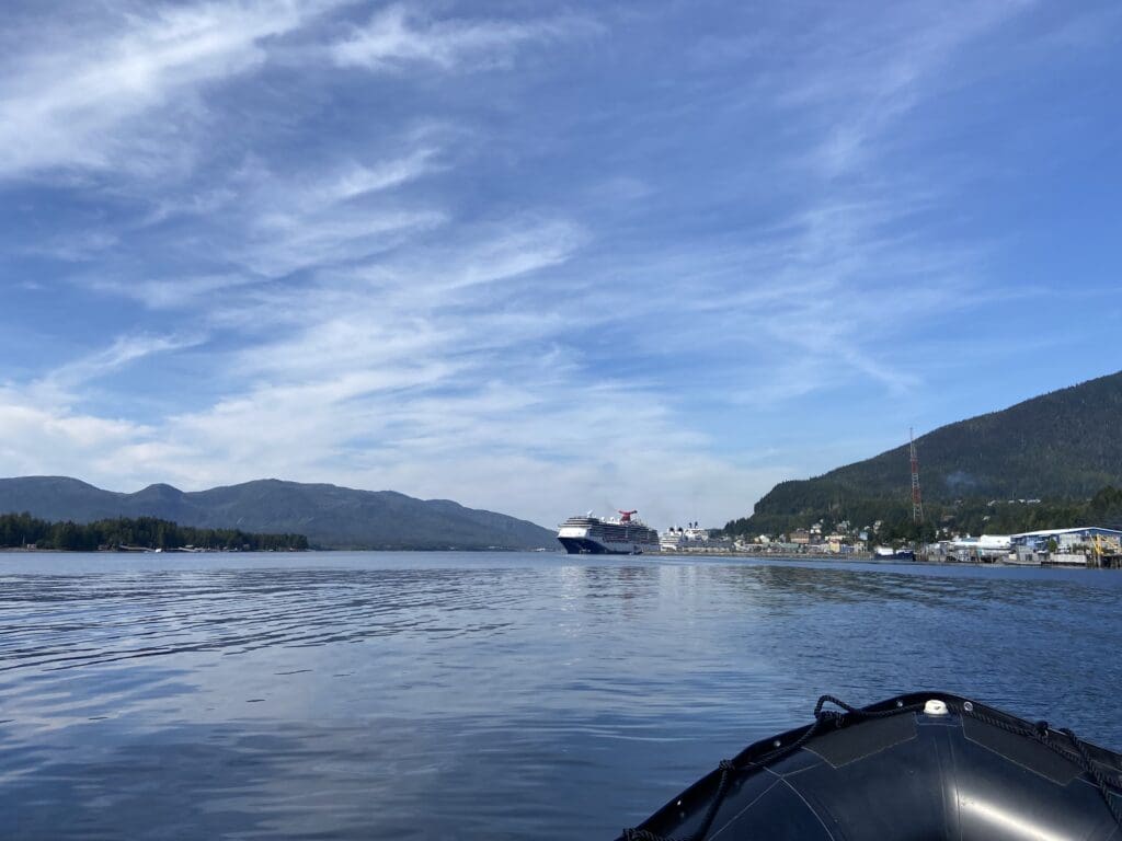 Escaping the cruise crowds Bow of Zodiac overlooking downtown Ketchikan with cruise ships
